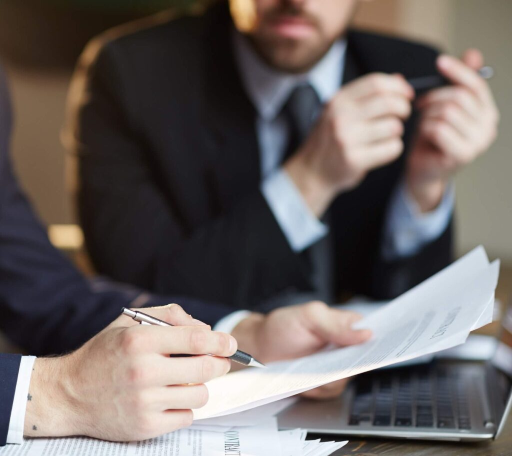 successful-business-partners-discussing-contract lawyers reviewing documents